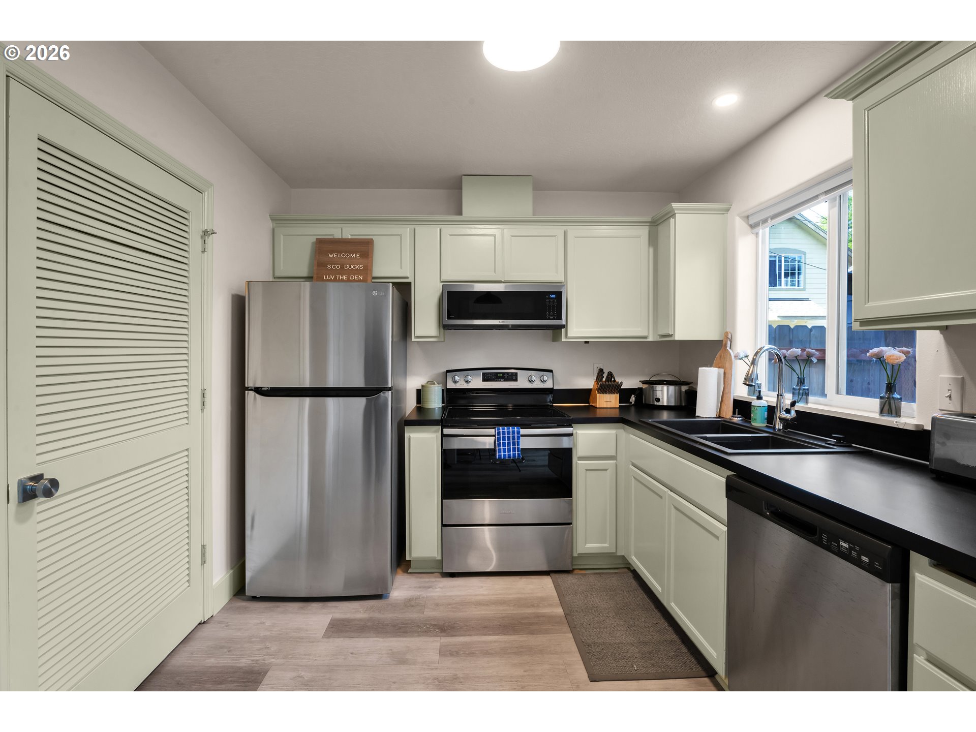 1733 Mill Alley Eugene, OR 97401 - Photo 7 of 26 a kitchen with granite countertop a refrigerator and a stove top oven