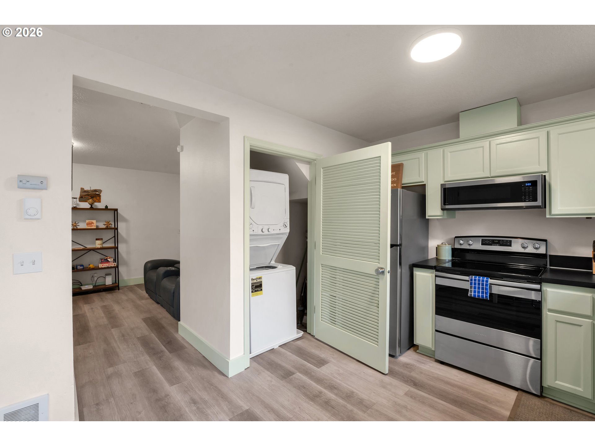 1733 Mill Alley Eugene, OR 97401 - Photo 8 of 26 a kitchen with stainless steel appliances kitchen island granite countertop a refrigerator and a stove top oven