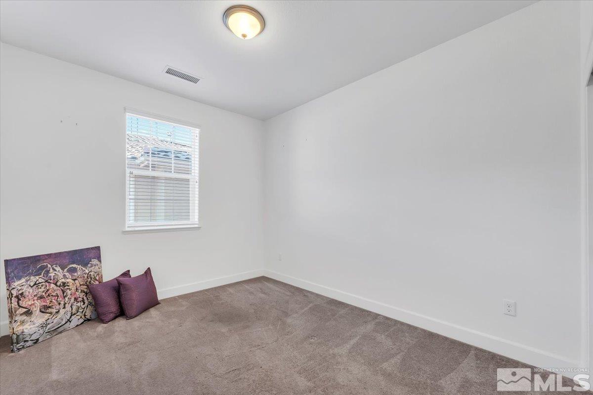 1884 Sea Horse Road, Unit B Reno, NV 89521 - Photo 19 of 29 a bedroom with a bed and a window