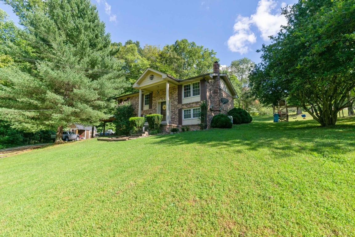 739 Thompson Road Pegram, TN 37143 - Photo 1 of 35 a front view of a house with garden