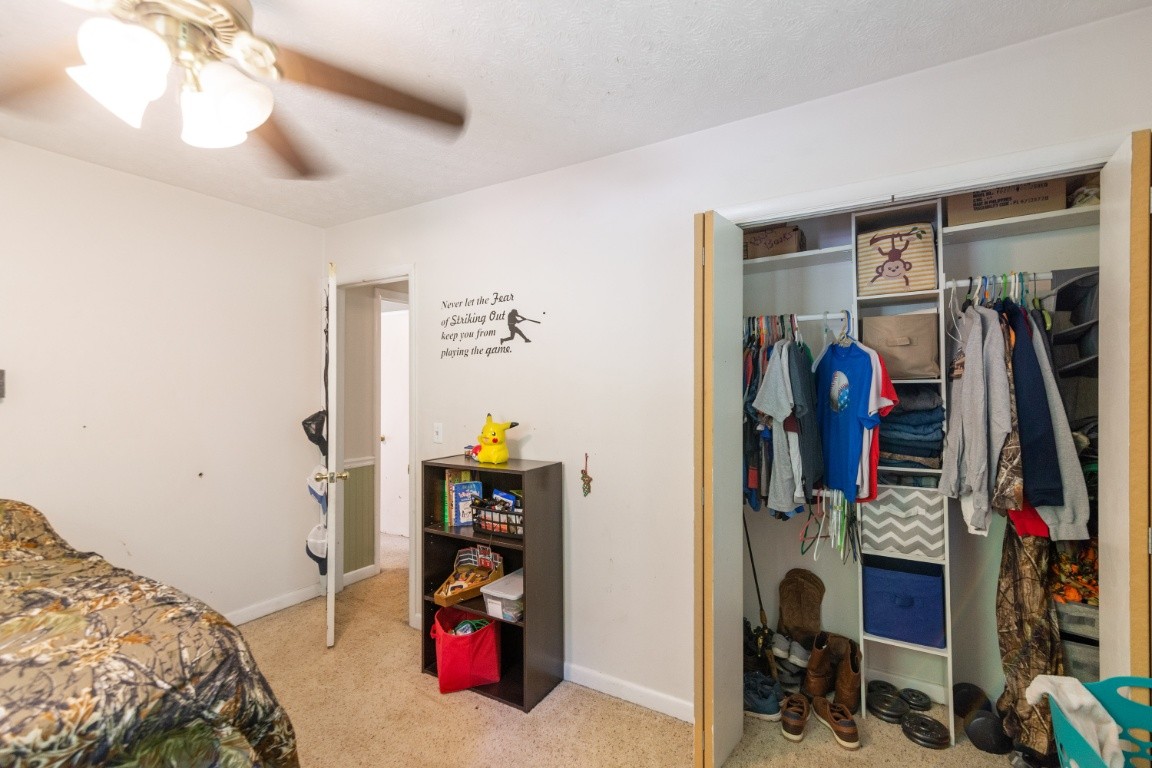 739 Thompson Road Pegram, TN 37143 - Photo 13 of 35 a bedroom with a bed a desk and closet