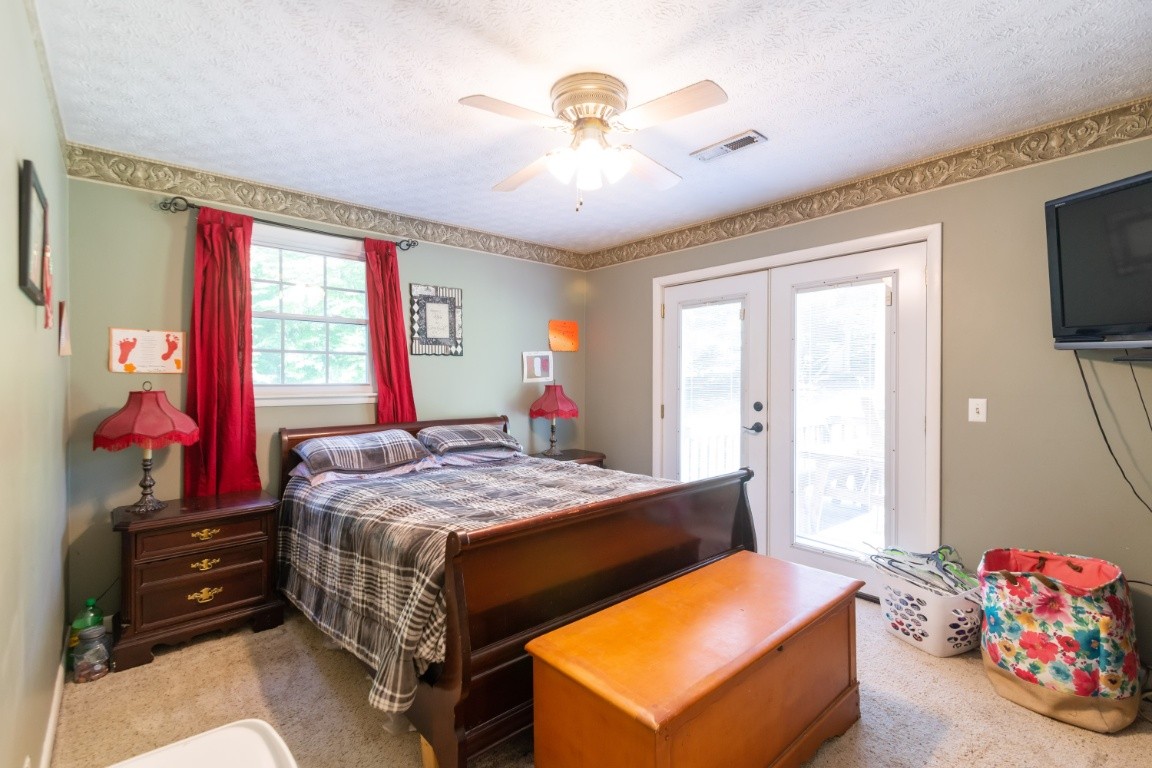 739 Thompson Road Pegram, TN 37143 - Photo 16 of 35 a bed room with a bed and a chandelier