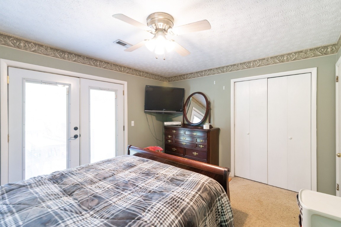 739 Thompson Road Pegram, TN 37143 - Photo 18 of 35 a bedroom with a bed and a chandelier