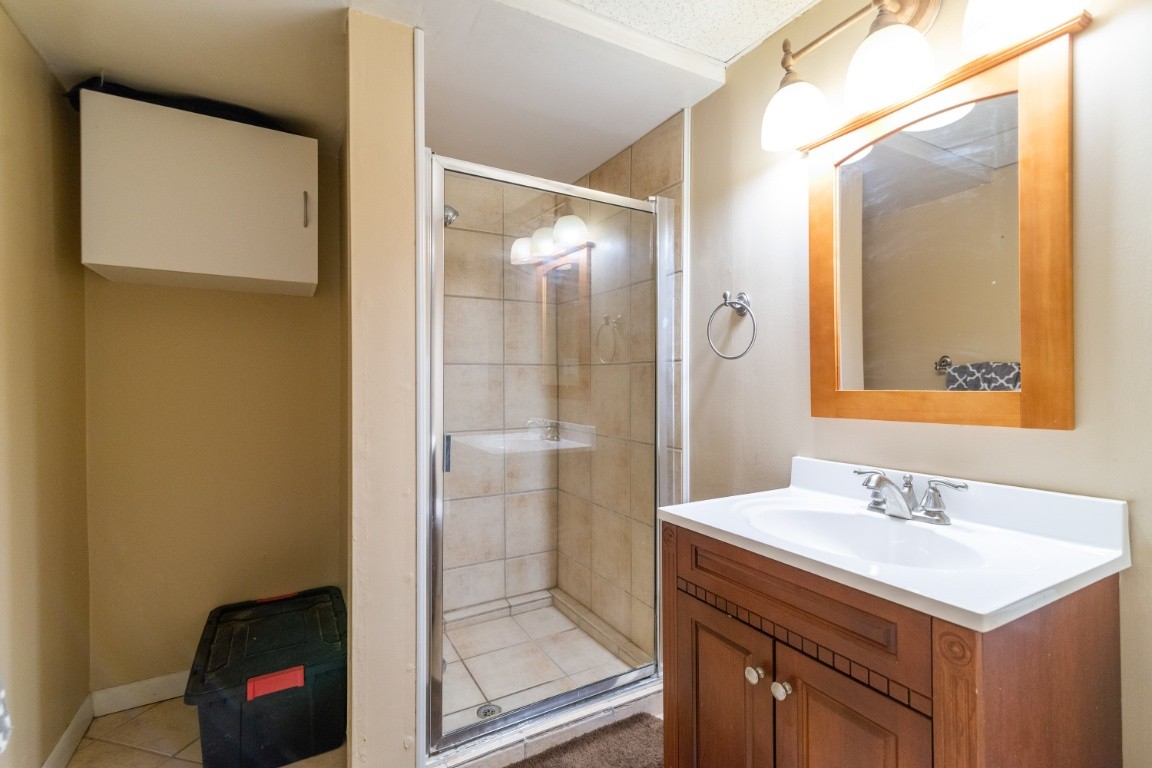 739 Thompson Road Pegram, TN 37143 - Photo 26 of 35 a bathroom with a sink a mirror and a shower