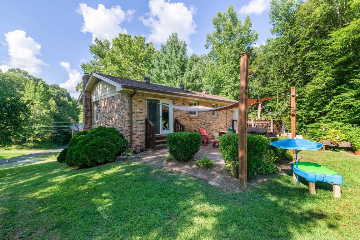 739 Thompson Road Pegram, TN 37143 - Photo 30 of 35 a view of a backyard with table and chairs potted plants and large tree