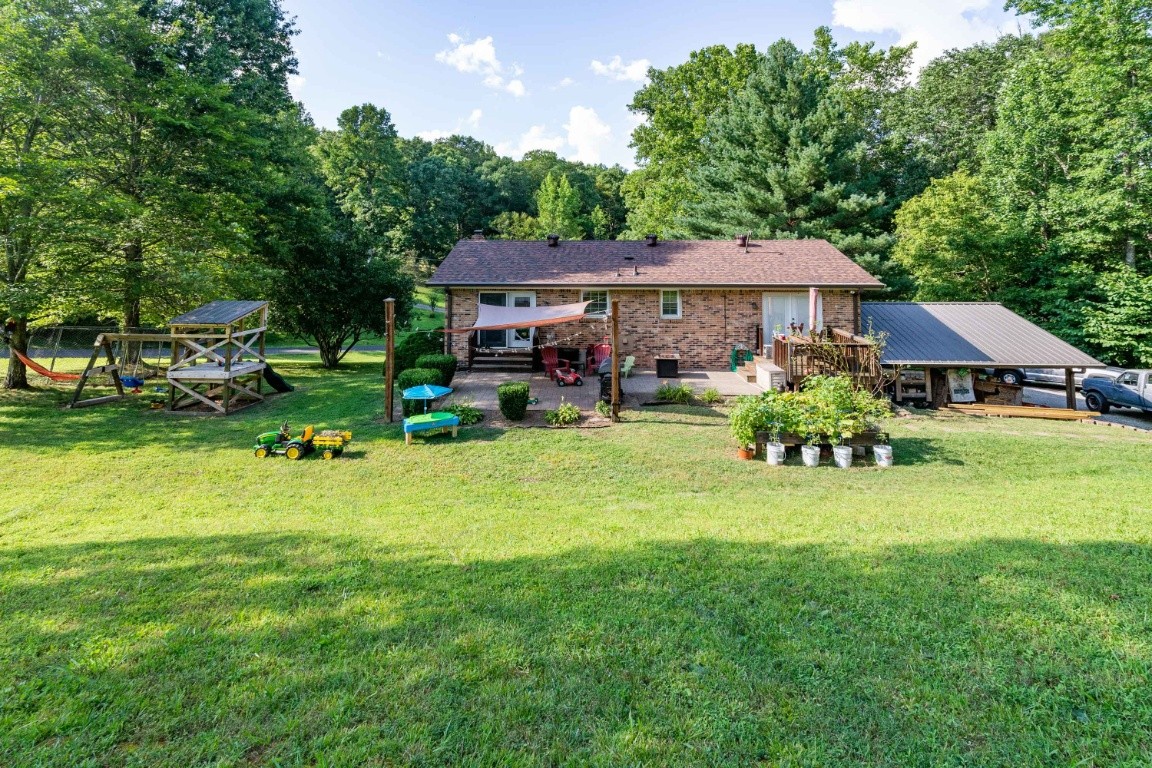 739 Thompson Road Pegram, TN 37143 - Photo 33 of 35 a view of a patio with table and chairs under an umbrella