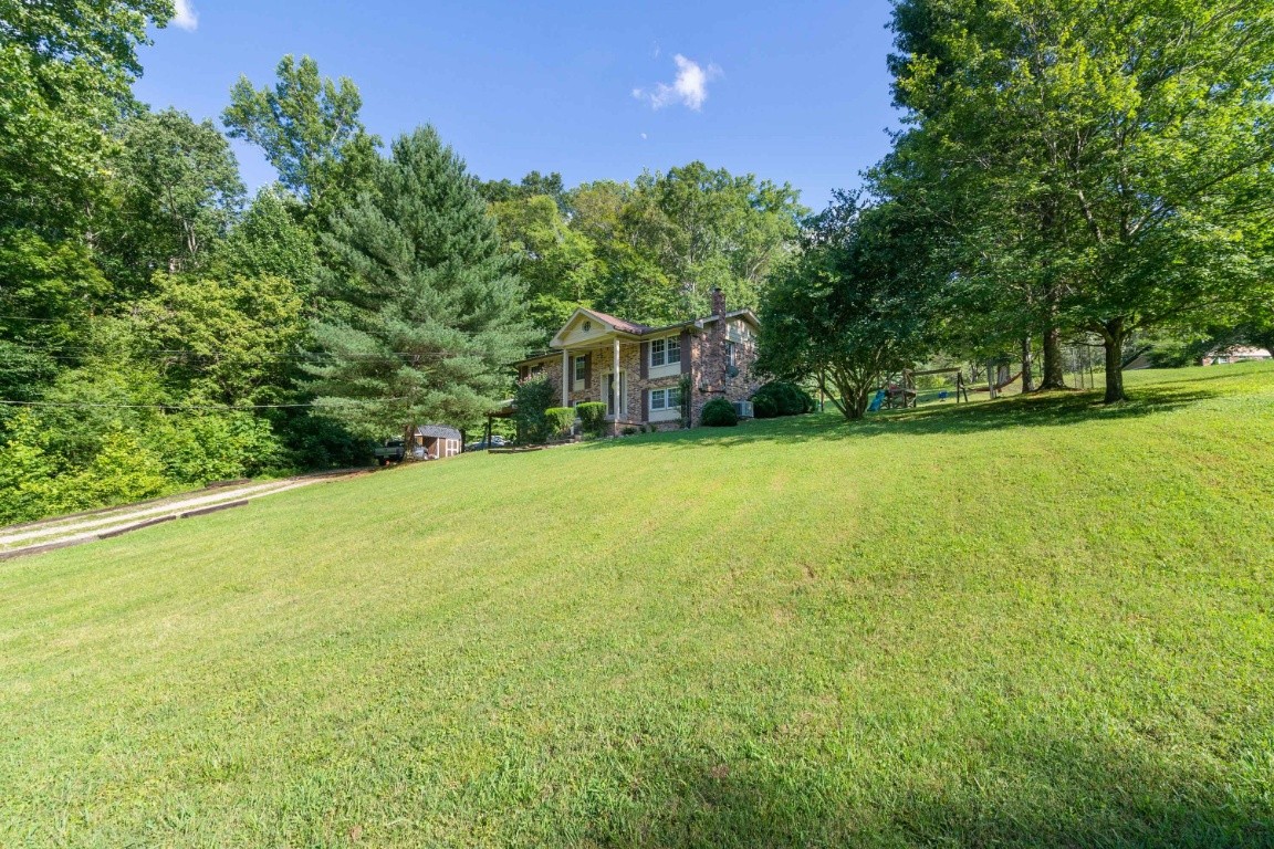 739 Thompson Road Pegram, TN 37143 - Photo 34 of 35 a view of a yard with a house in the background