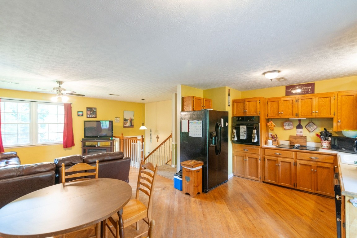 739 Thompson Road Pegram, TN 37143 - Photo 7 of 35 a living room with stainless steel appliances kitchen island granite countertop a table chairs and a refrigerator