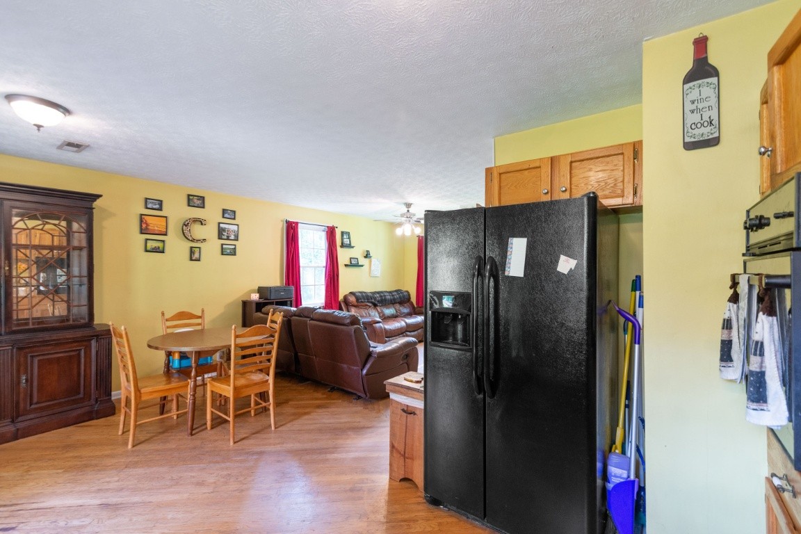 739 Thompson Road Pegram, TN 37143 - Photo 10 of 35 a living room with stainless steel appliances furniture a refrigerator and a kitchen view