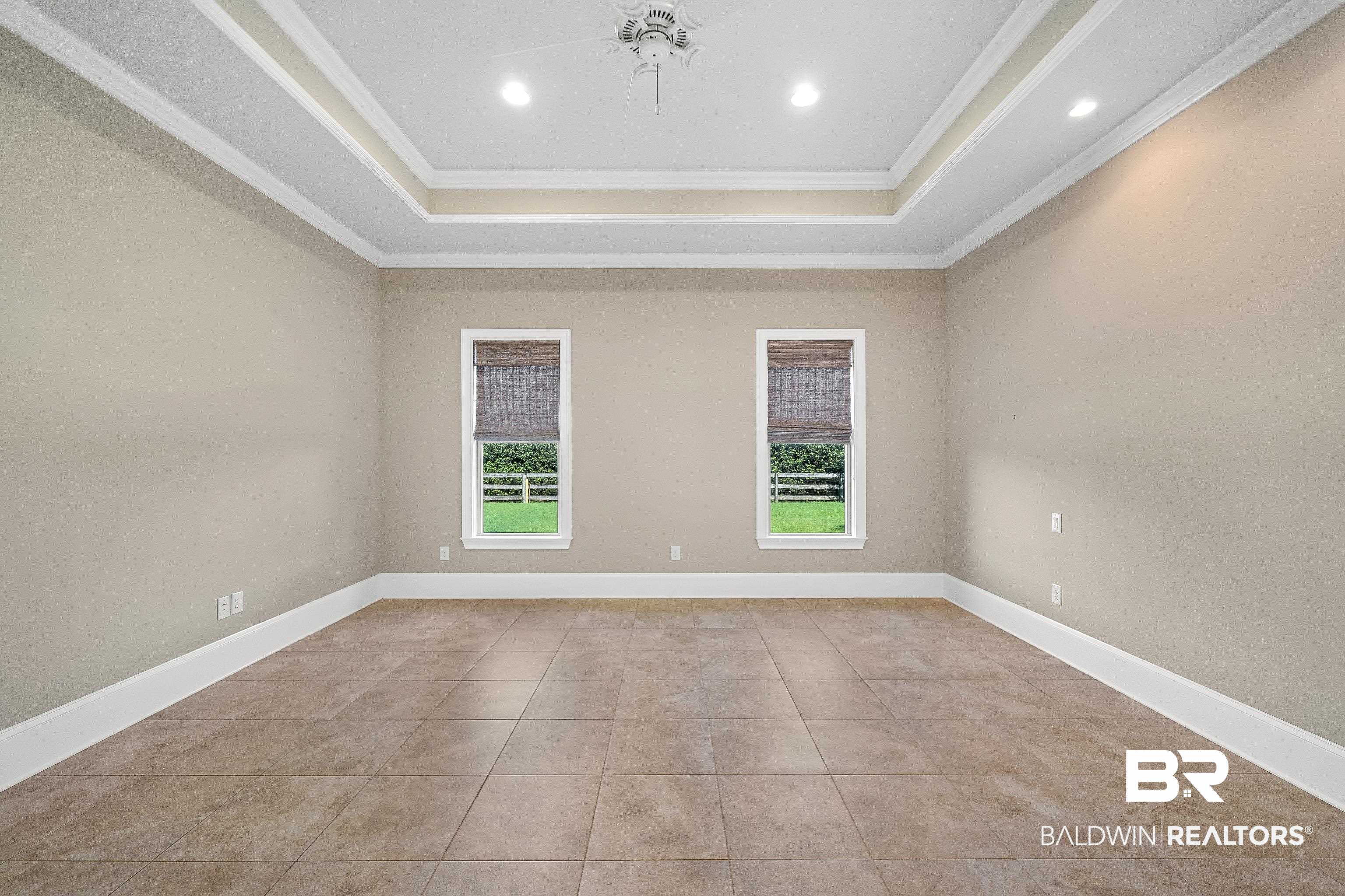 17663 Burwick Loop Fairhope, AL 36532 - Photo 26 of 41 Tiled empty room featuring a raised ceiling and crown molding
