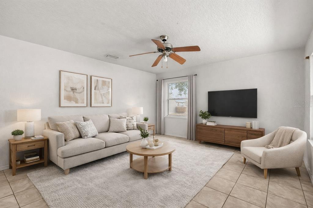 809 Talladega Street Leesburg, FL 34748 - Photo 3 of 13 a living room with furniture and a flat screen tv