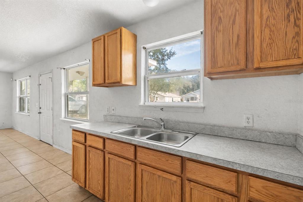 809 Talladega Street Leesburg, FL 34748 - Photo 4 of 13 a kitchen with a sink and cabinets