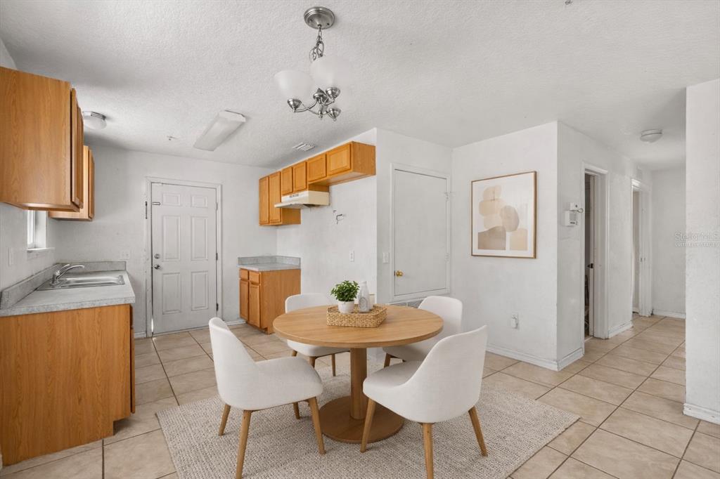809 Talladega Street Leesburg, FL 34748 - Photo 5 of 13 a view of a dining room with furniture and wooden floor