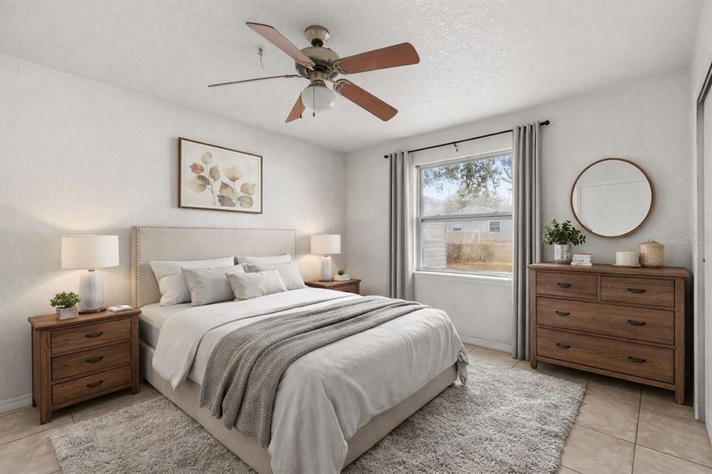 809 Talladega Street Leesburg, FL 34748 - Photo 7 of 13 a bedroom with a bed and a window