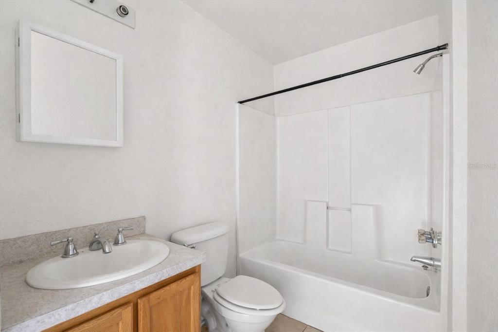 809 Talladega Street Leesburg, FL 34748 - Photo 8 of 13 a bathroom with a sink toilet and shower