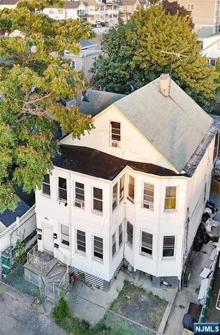 a view of a white building with large windows