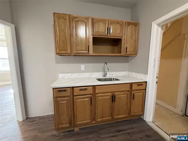 a bathroom with a granite countertop double vanity sink and mirror
