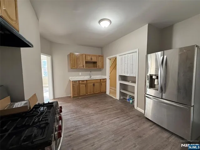 a kitchen with a refrigerator and a stove top oven