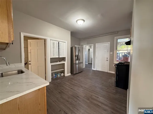 a view of a kitchen cabinets a sink and a refrigerator