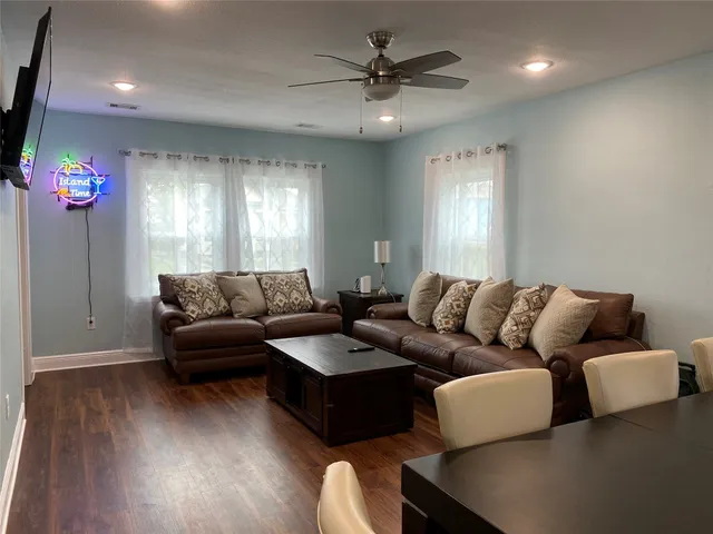 a living room with furniture and a chandelier