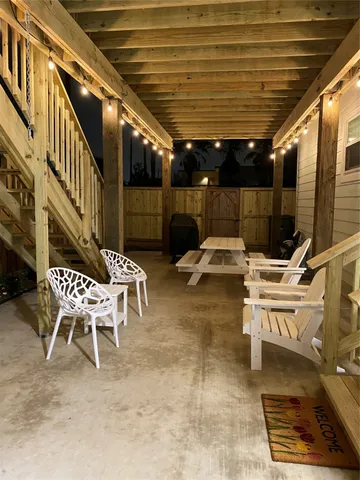 a view of a patio with table and chairs and potted plants