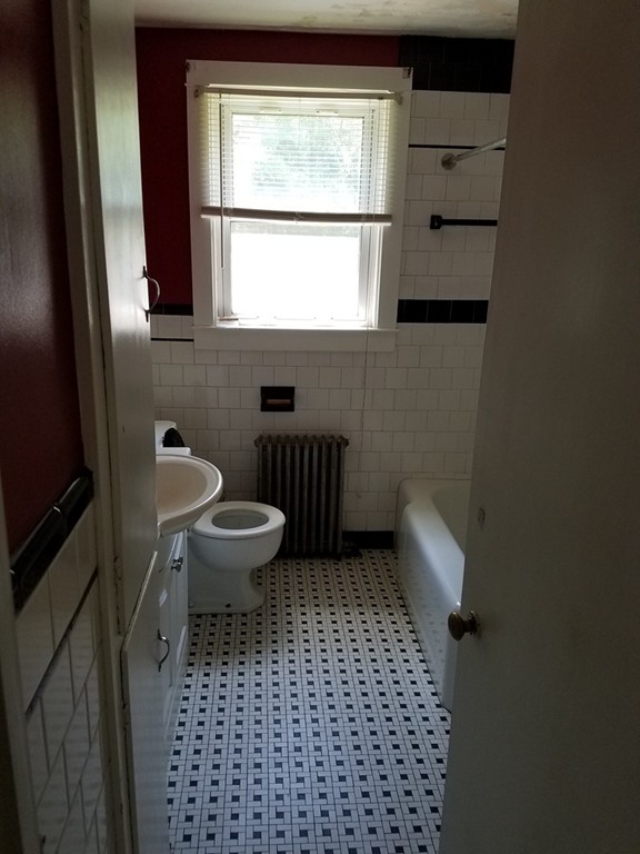 166 Hathaway Road Acushnet, MA 02743 - Photo 10 of 14 a bathroom with a toilet a sink and a window