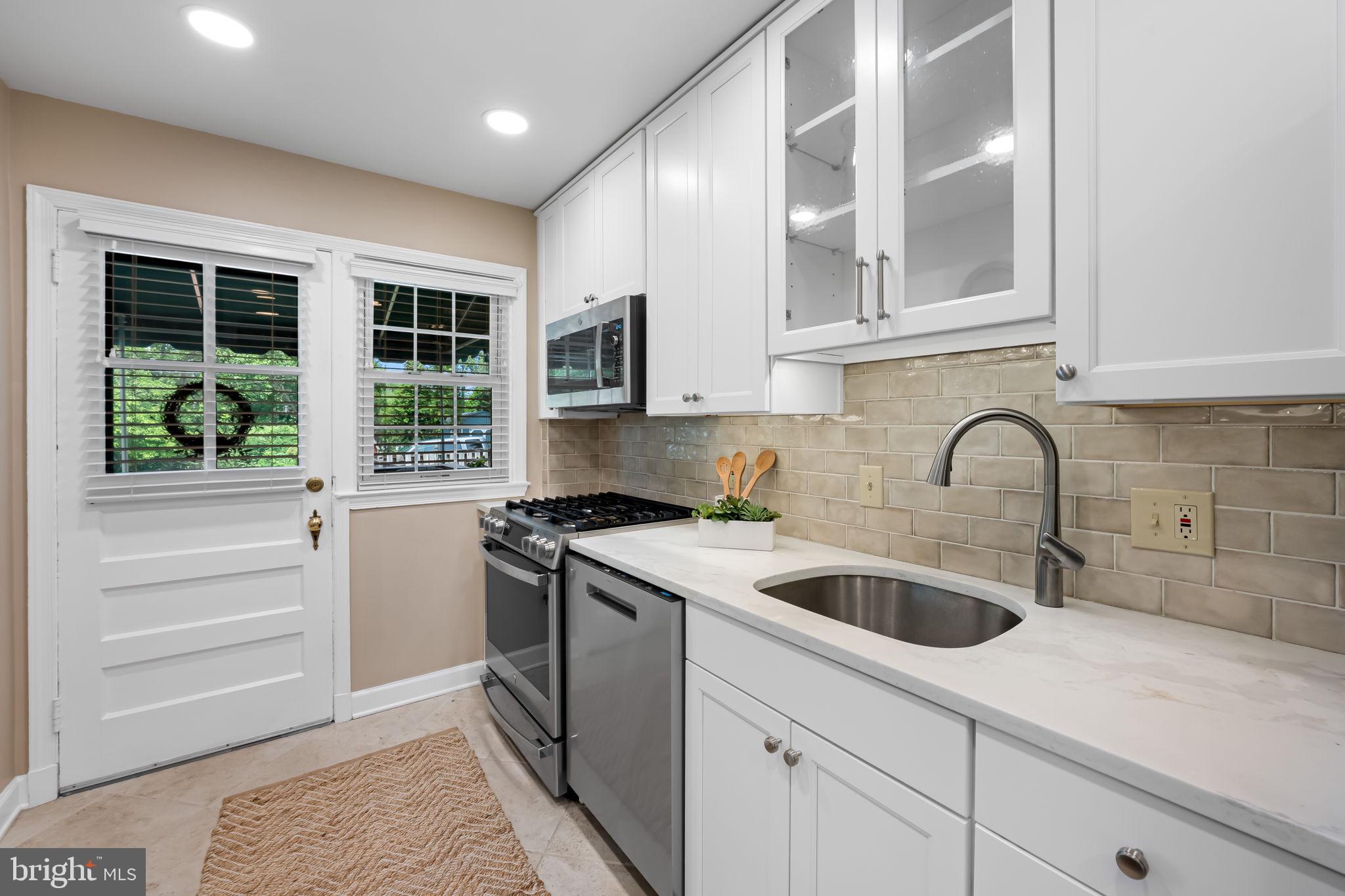 210 Stanmore Road Baltimore, MD 21212 - Photo 11 of 39 a kitchen with stainless steel appliances granite countertop a sink and a stove