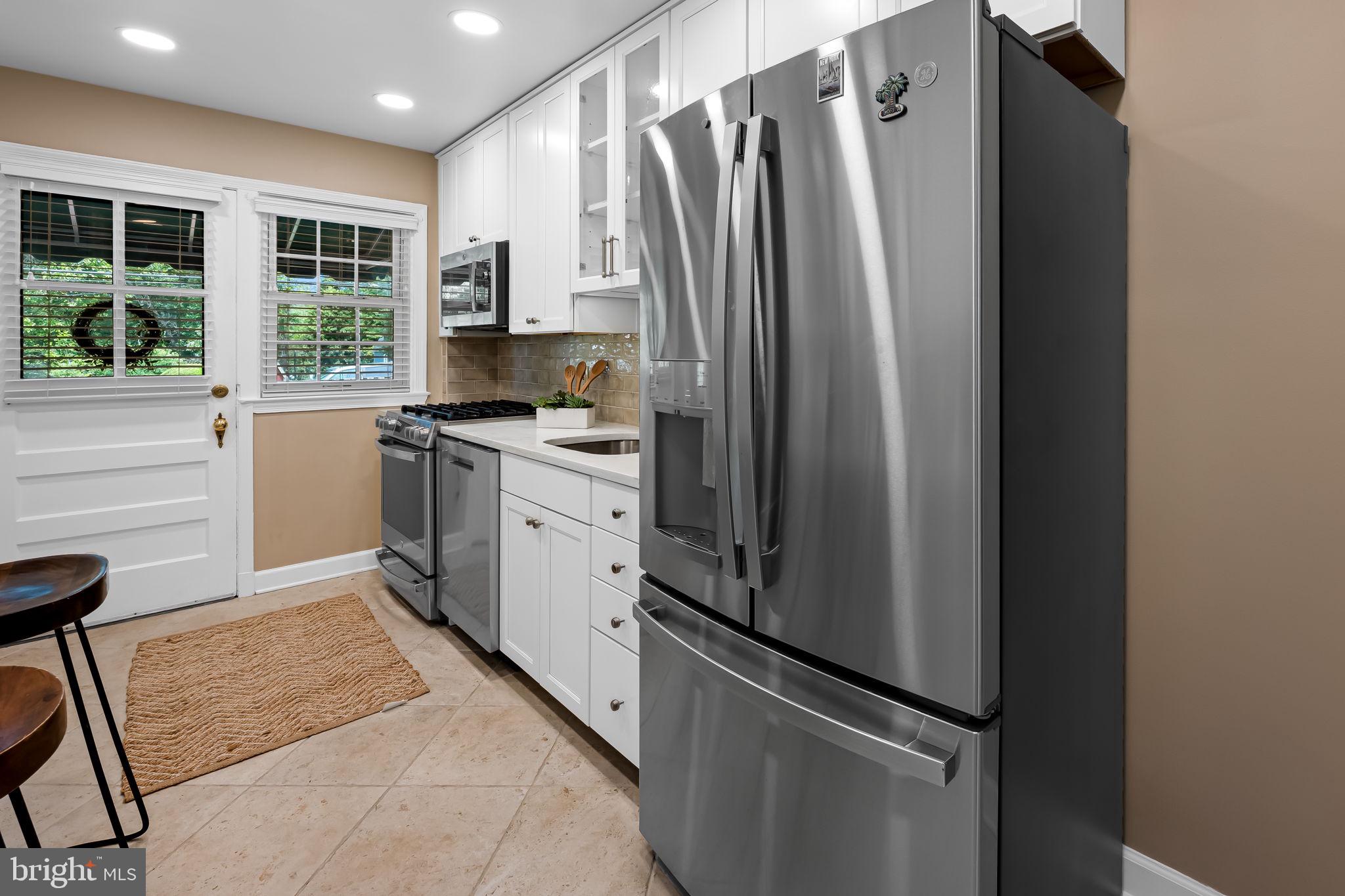 210 Stanmore Road Baltimore, MD 21212 - Photo 12 of 39 a kitchen with stainless steel appliances a refrigerator sink and cabinets