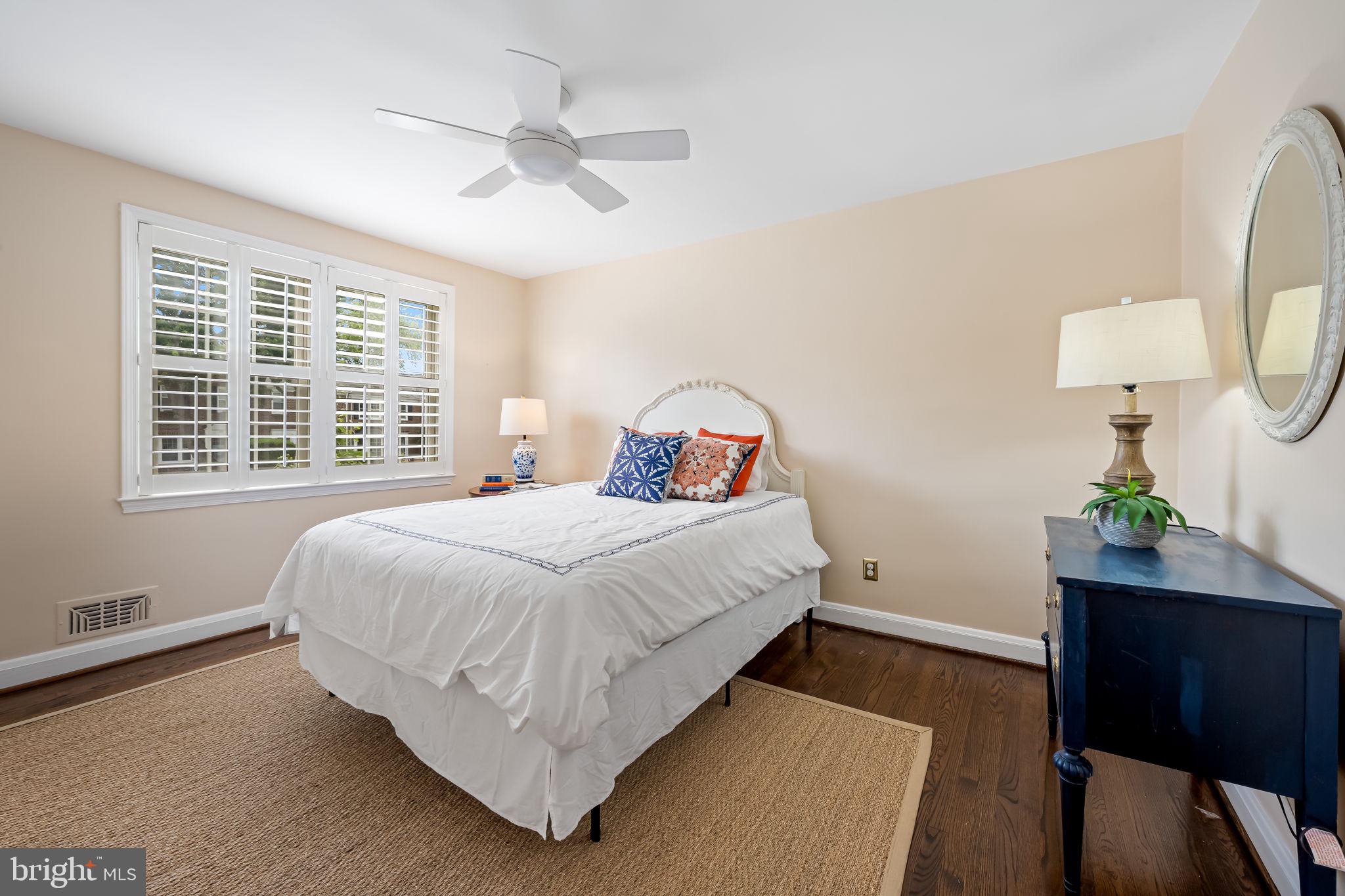 210 Stanmore Road Baltimore, MD 21212 - Photo 20 of 39 a bedroom with a bed window with table and chair