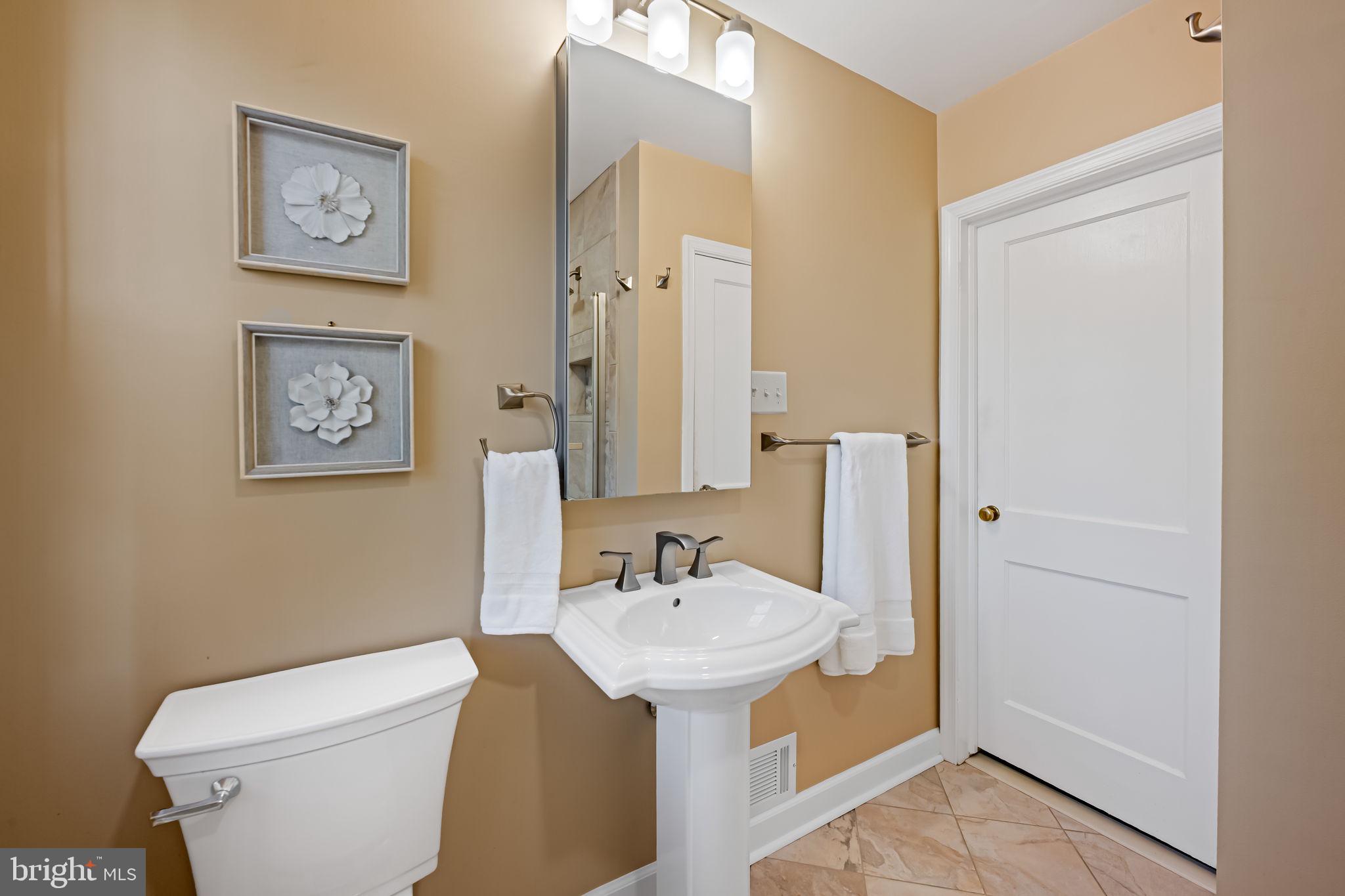 210 Stanmore Road Baltimore, MD 21212 - Photo 23 of 39 a bathroom with a sink mirror and toilet
