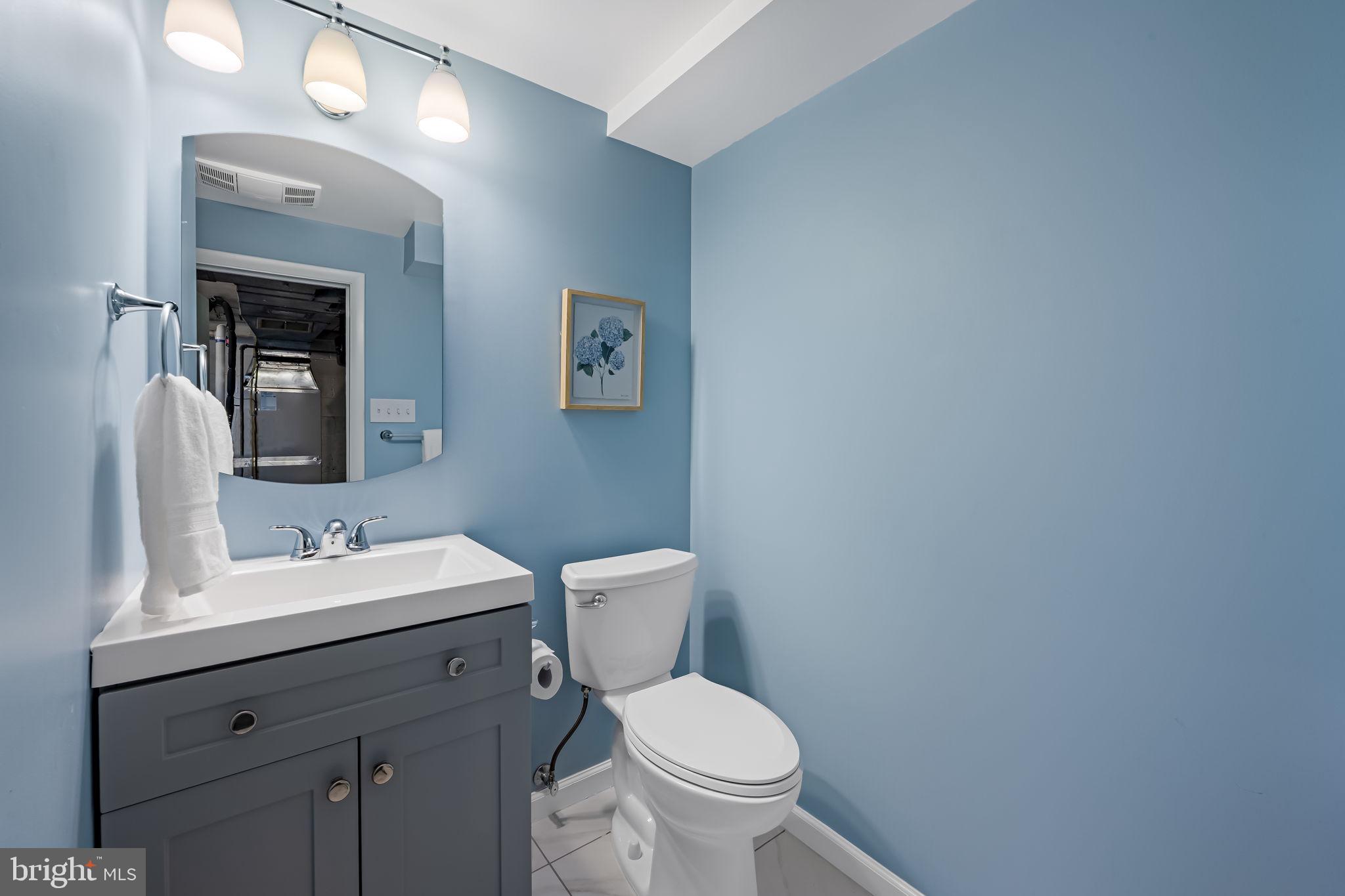 210 Stanmore Road Baltimore, MD 21212 - Photo 29 of 39 a bathroom with a toilet sink and mirror