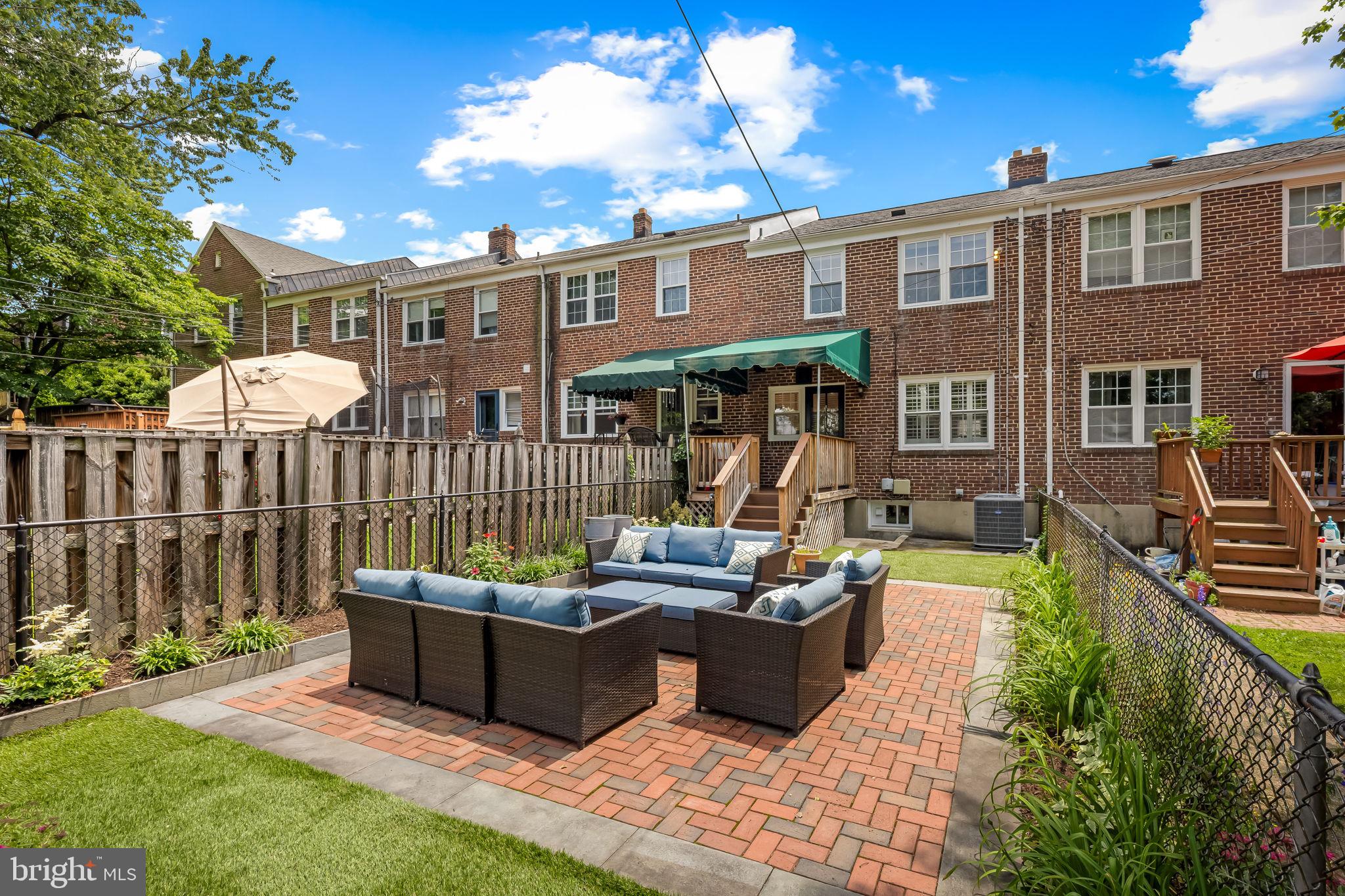 210 Stanmore Road Baltimore, MD 21212 - Photo 35 of 39 a view of a patio with couches chairs potted plants and wooden fence