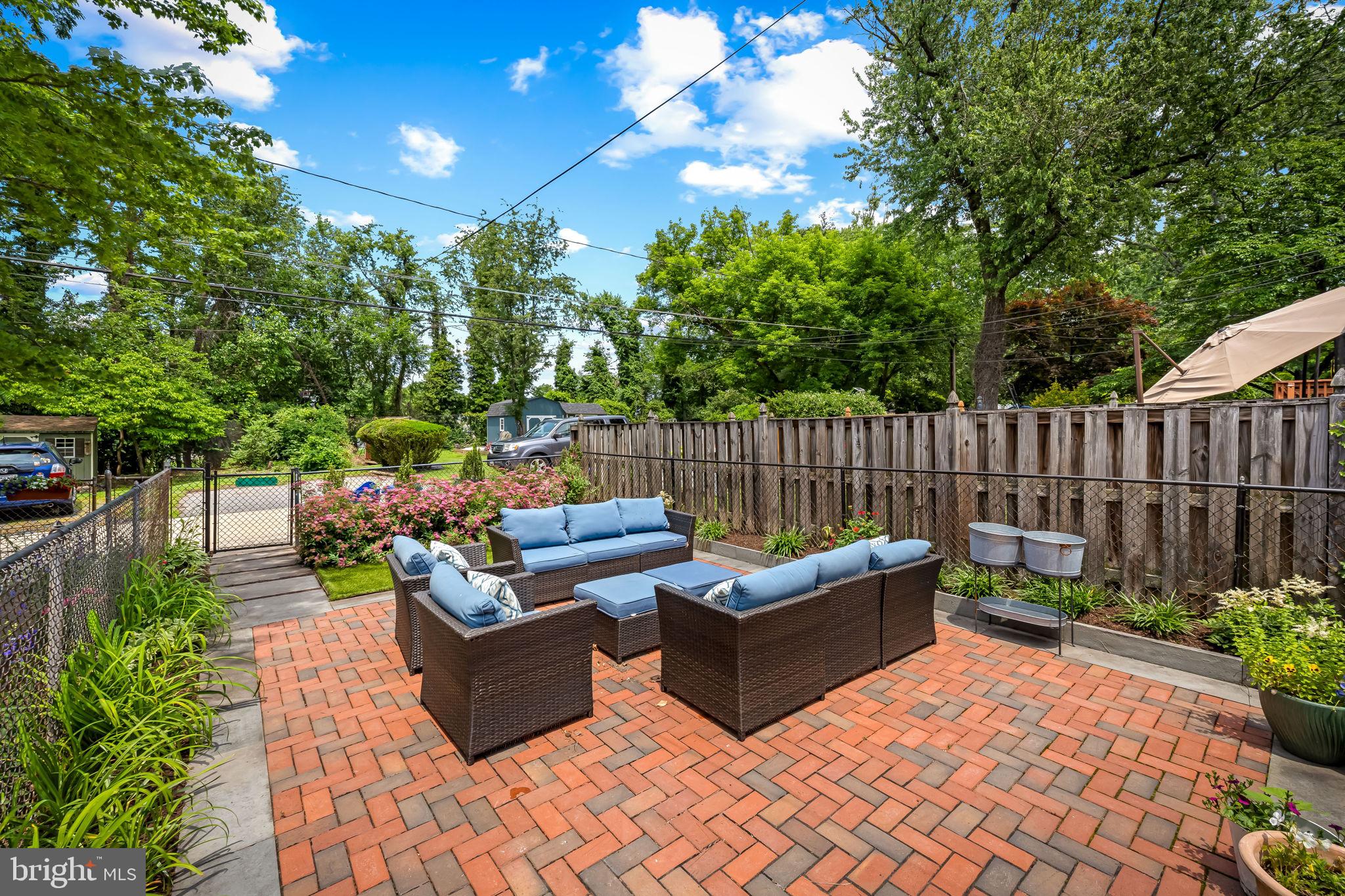 210 Stanmore Road Baltimore, MD 21212 - Photo 38 of 39 a view of a couches in the patio with potted plants and large trees