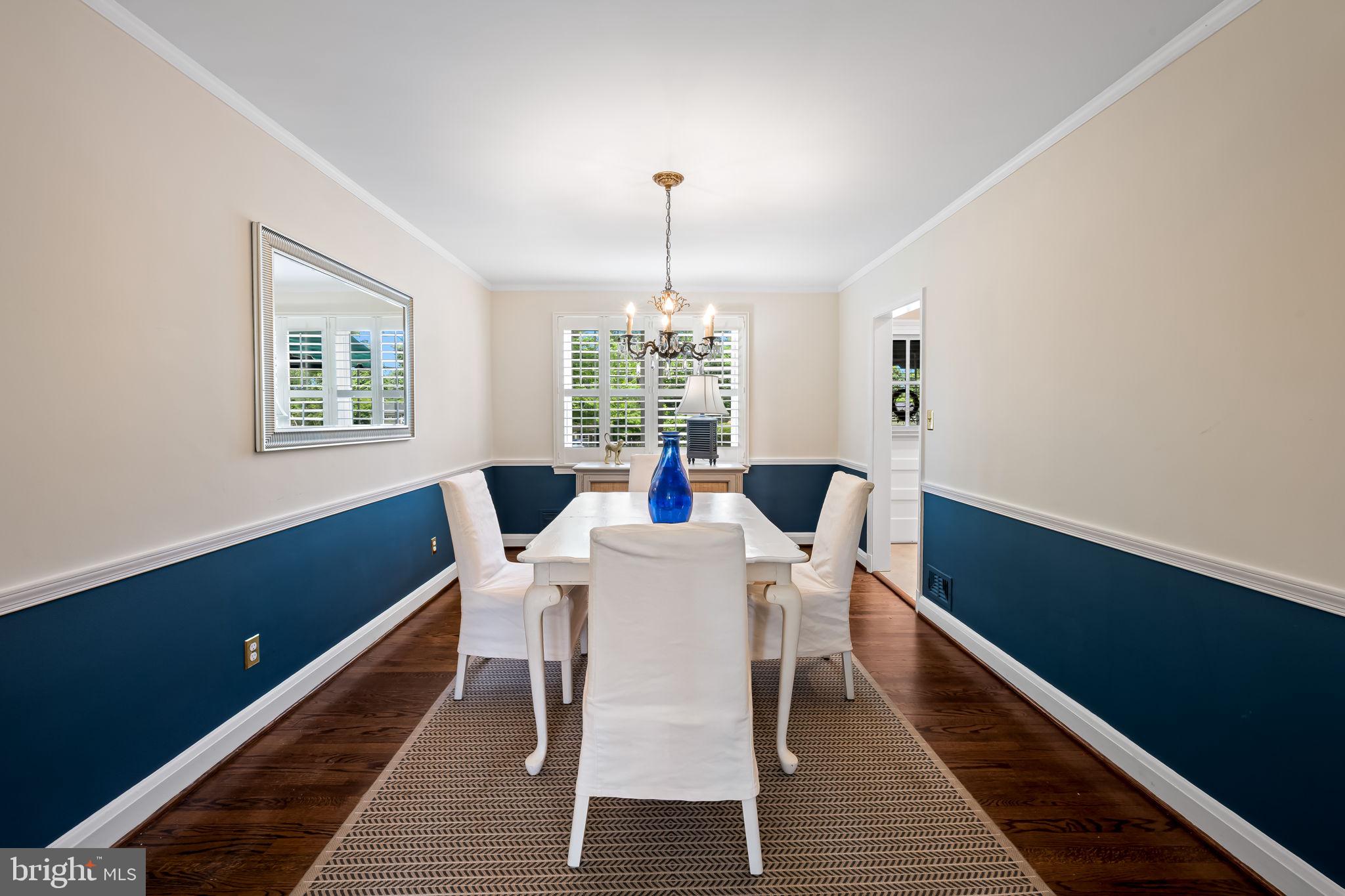210 Stanmore Road Baltimore, MD 21212 - Photo 9 of 39 a dining room with furniture a chandelier and wooden floor