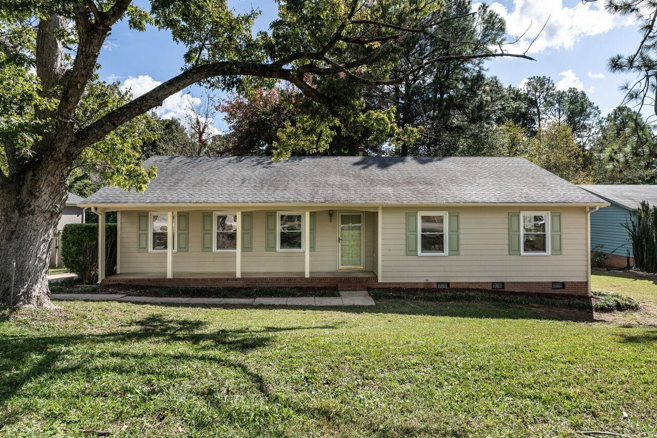 3300 Blue Ridge Road Raleigh, NC 27612 - Photo 1 of 25 a view of a house with a yard