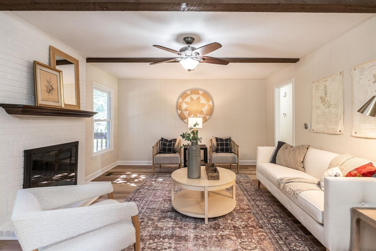 3300 Blue Ridge Road Raleigh, NC 27612 - Photo 13 of 25 a living room with furniture a fireplace and a large mirror