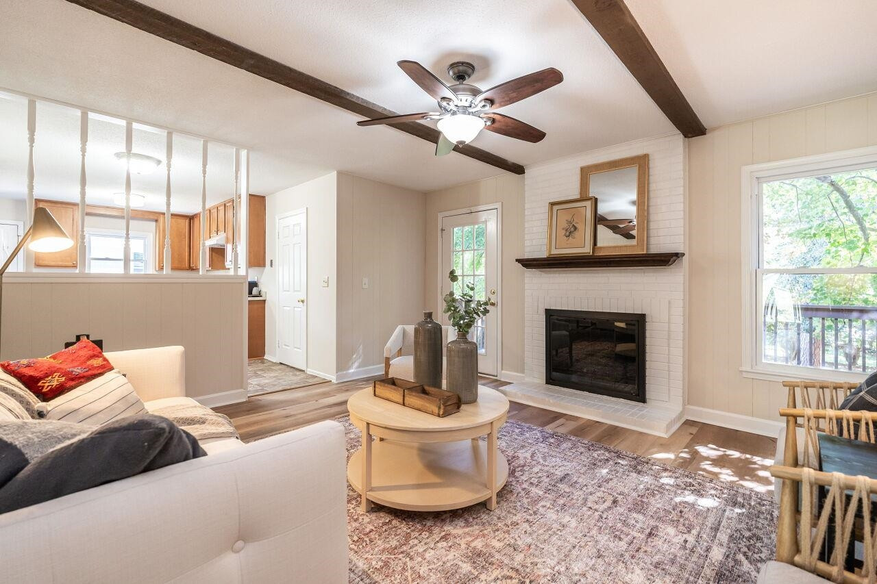 3300 Blue Ridge Road Raleigh, NC 27612 - Photo 15 of 25 a living room with furniture and a fireplace