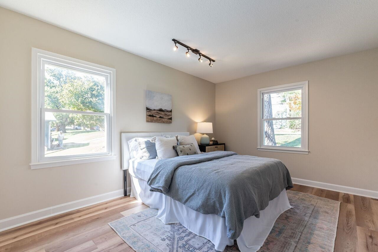 3300 Blue Ridge Road Raleigh, NC 27612 - Photo 19 of 25 a bedroom with a bed and a window