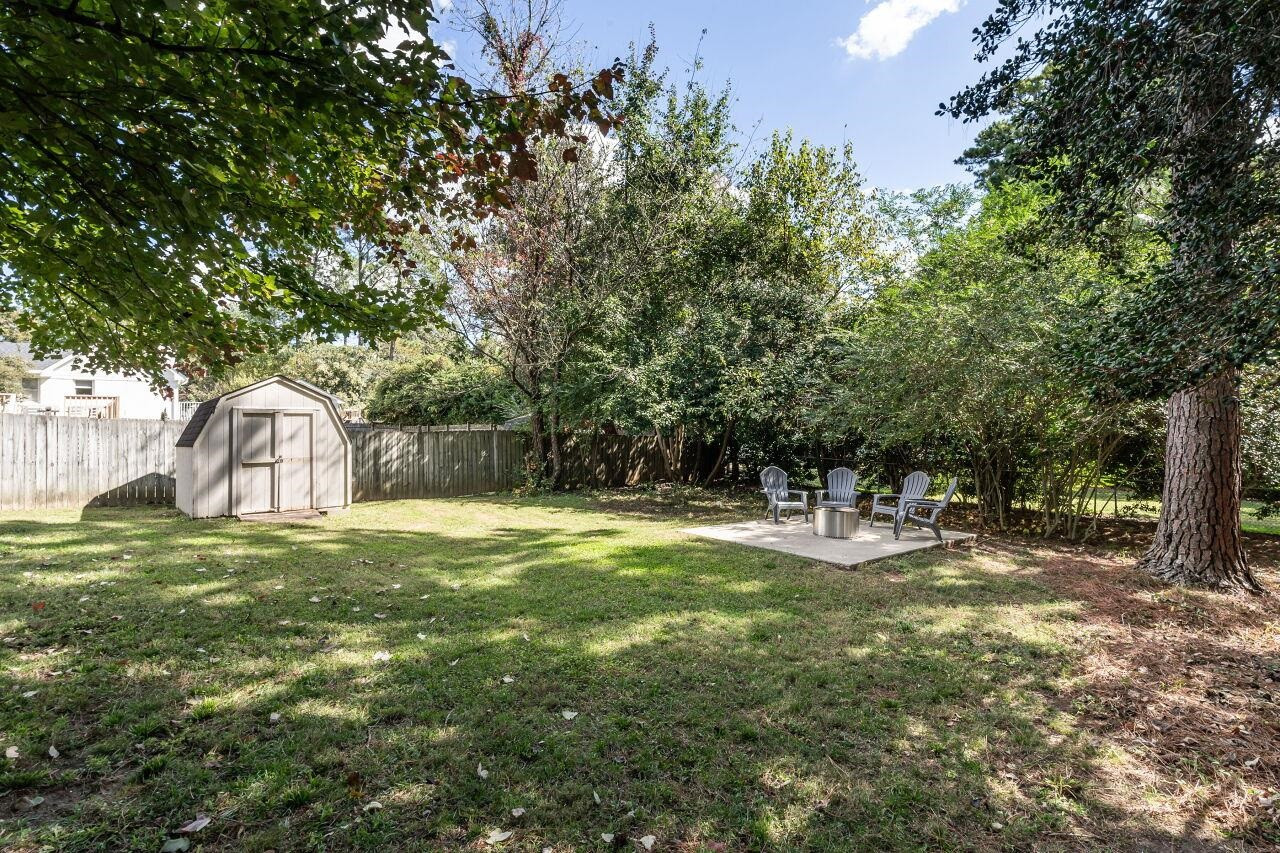 3300 Blue Ridge Road Raleigh, NC 27612 - Photo 23 of 25 a backyard of a house with table and chairs