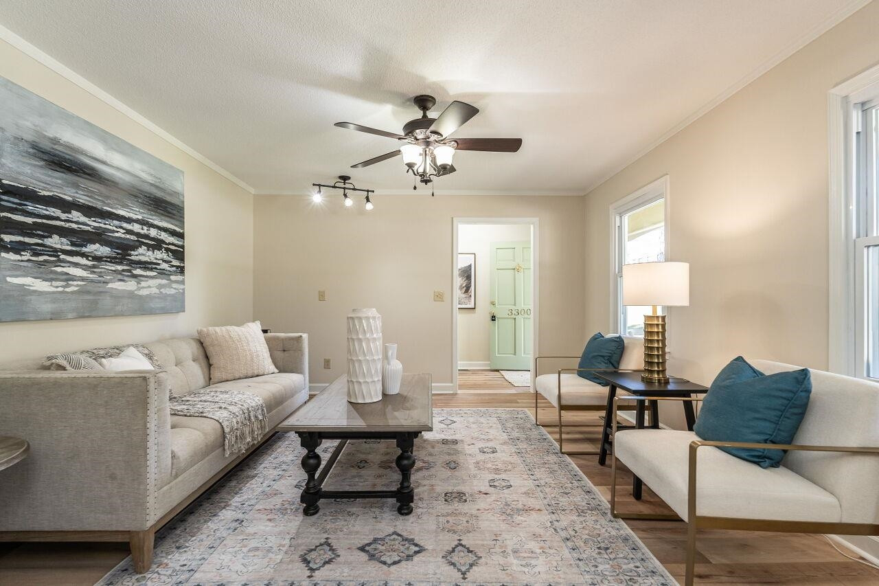3300 Blue Ridge Road Raleigh, NC 27612 - Photo 5 of 25 a living room with furniture and a chandelier