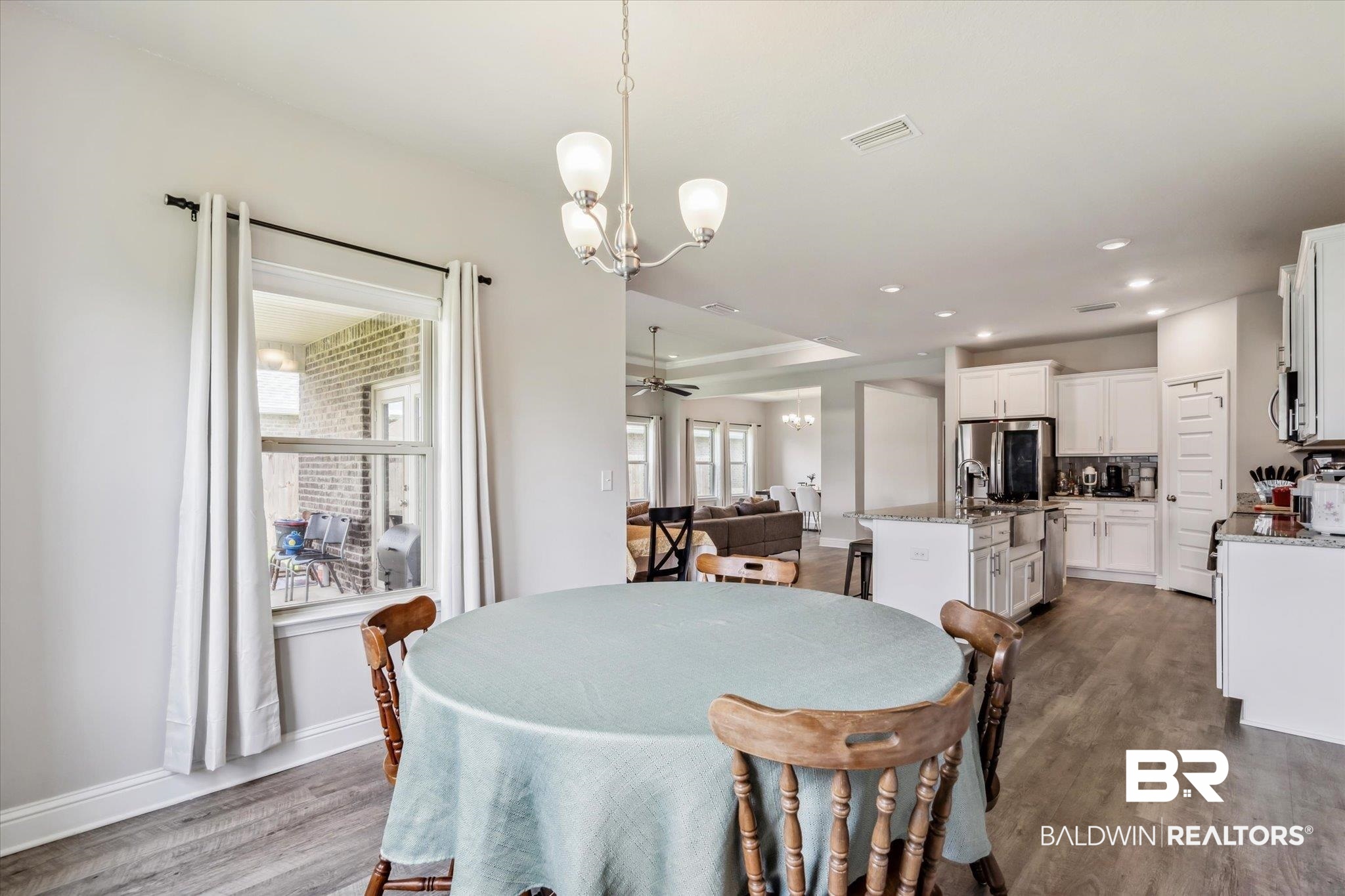 10501 Loamy Avenue Mobile, AL 36695 - Photo 12 of 30 Dining area featuring ceiling fan with notable chandelier and dark hardwood / wood-style floors