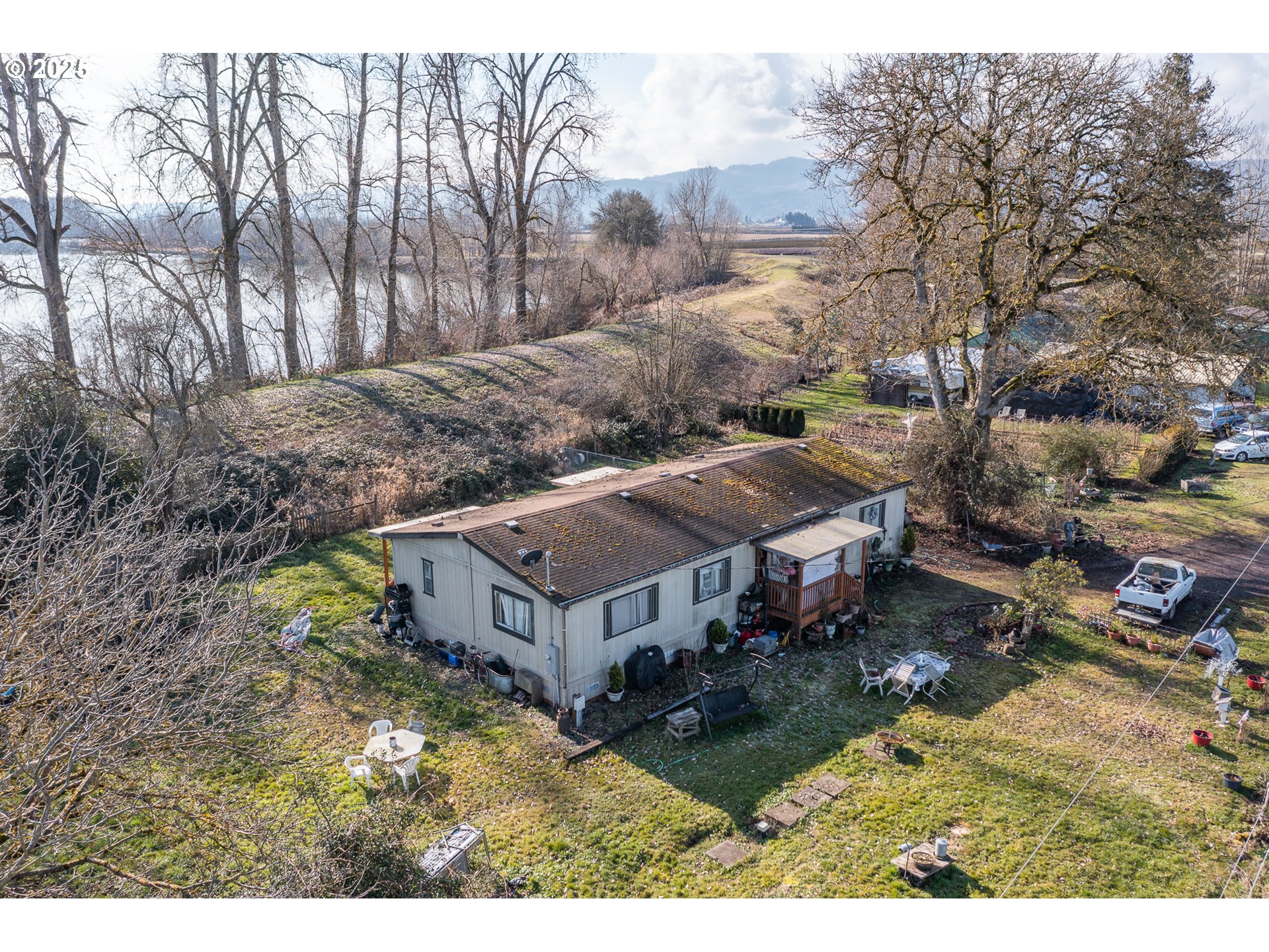 35308 Riverside Lane Scappoose, OR 97056 - Photo 19 of 48 a view of a house with a big yard plants and large trees
