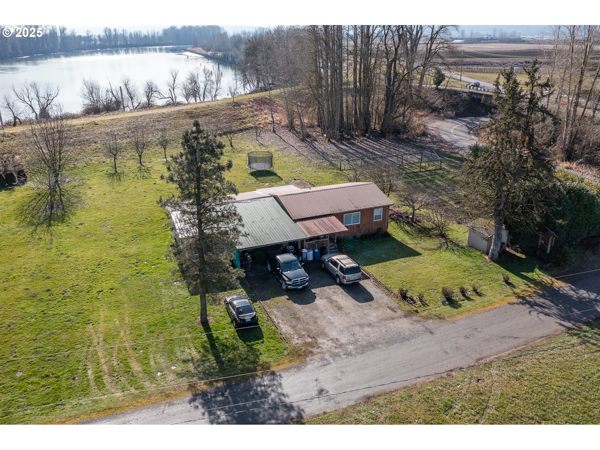 35308 Riverside Lane Scappoose, OR 97056 - Photo 22 of 48 a view of a backyard with plants and lake view