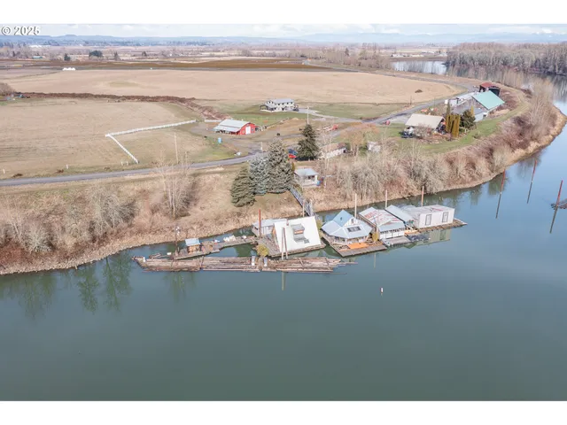 a view of a house with a yard and lake view