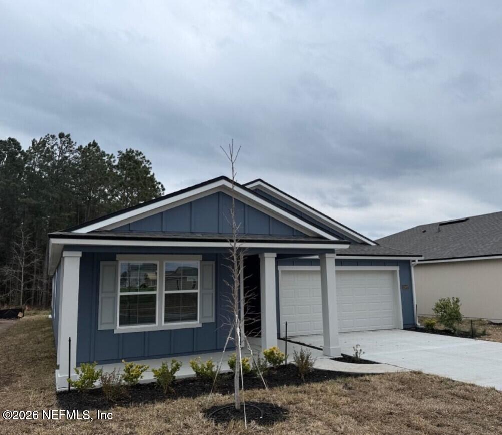 12407 Russian Olive Road Jacksonville, FL 32218 - Photo 3 of 61 a front view of a house with garden
