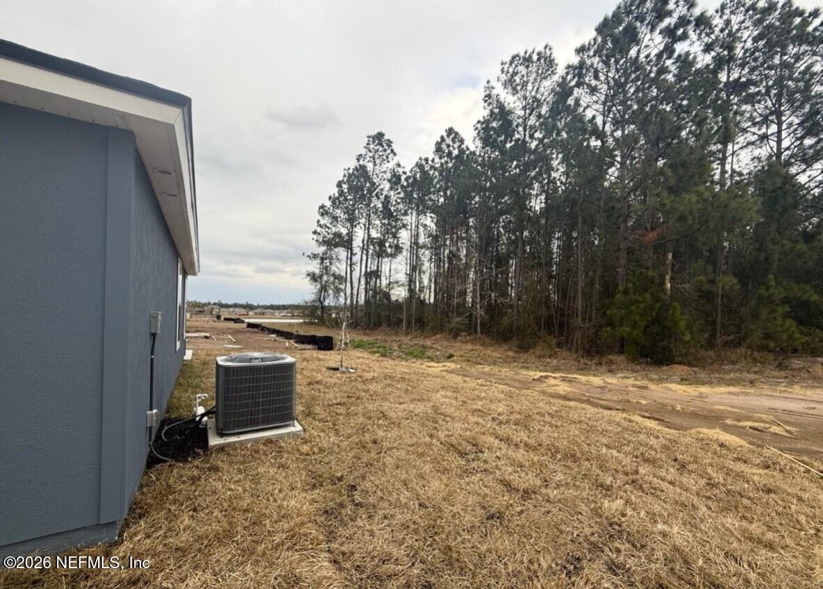 12407 Russian Olive Road Jacksonville, FL 32218 - Photo 6 of 61 a backyard of a house with lots of green space