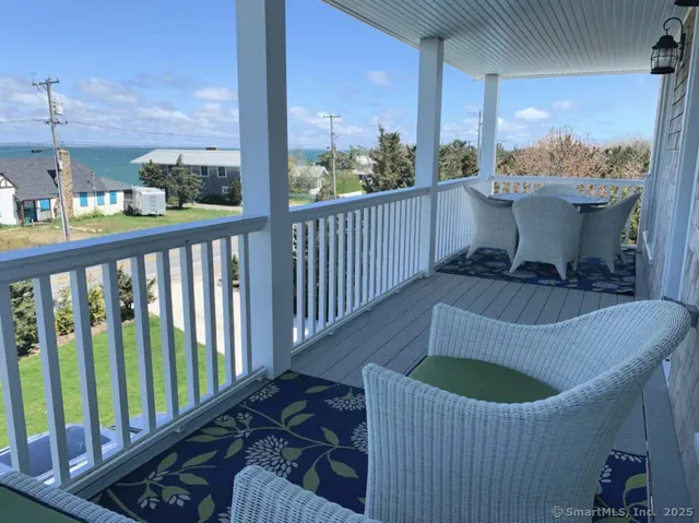 a view of a balcony with chair and wooden floor