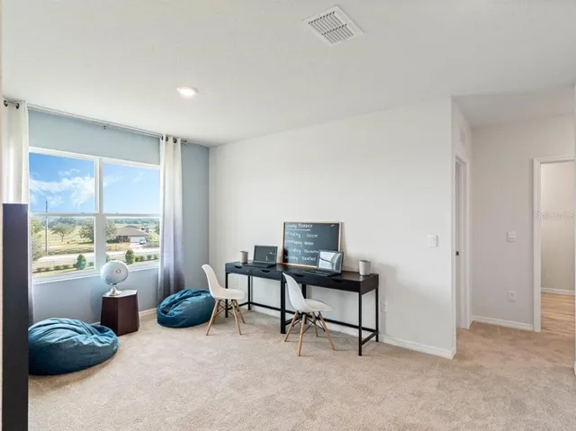 a view of a livingroom with furniture and a window