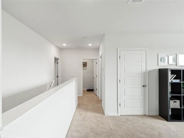 a view of a hallway with wooden shelves