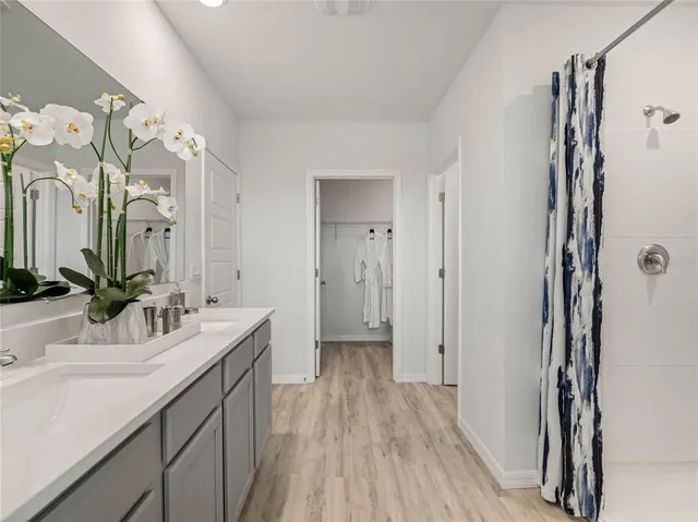 a bathroom with a double vanity sink and mirror